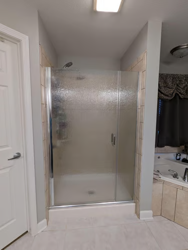 Semi-frameless shower enclosure